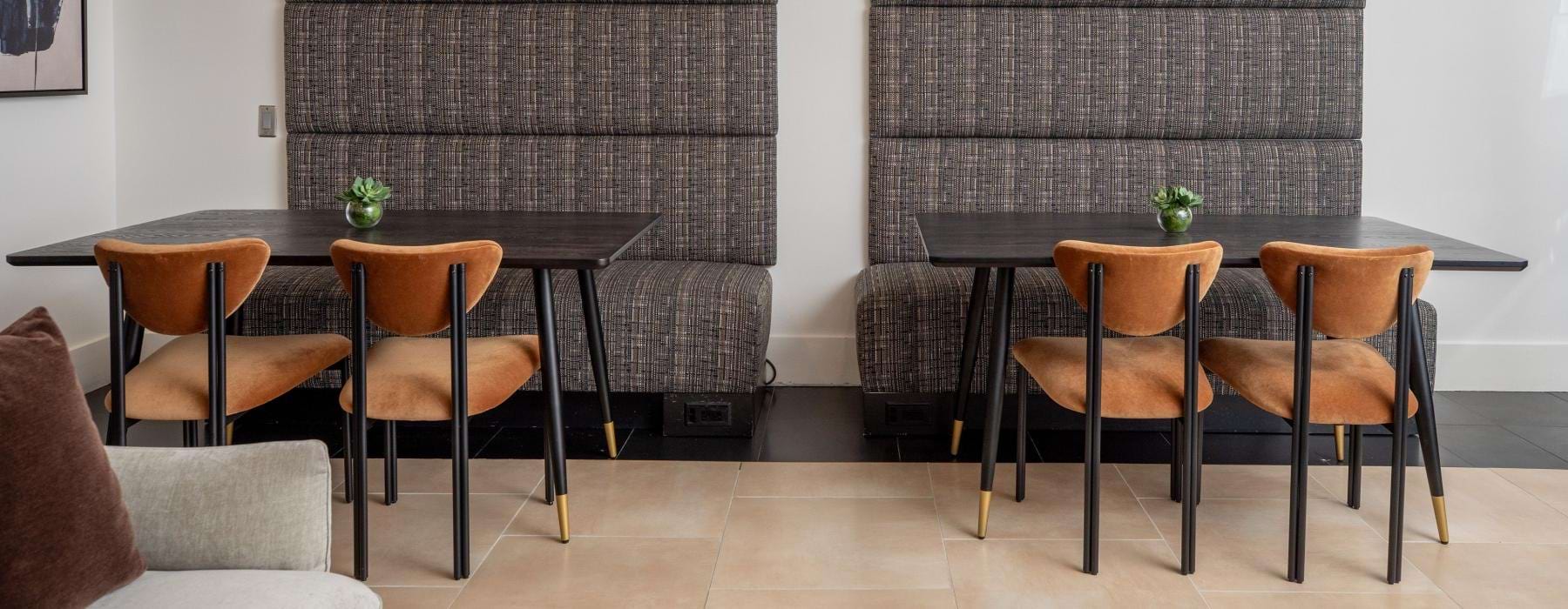 a room with a table chairs and a wall with lights